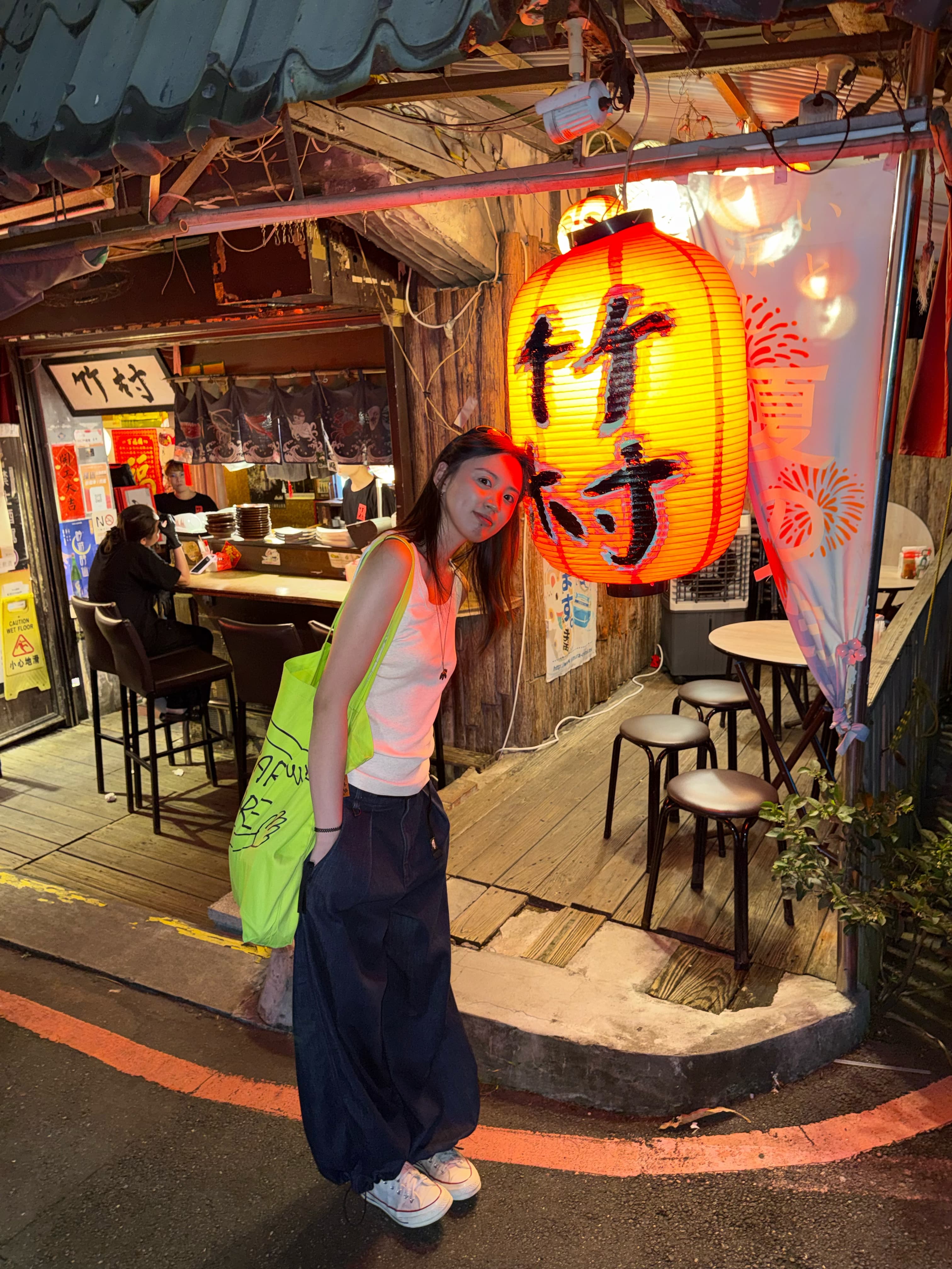 Eryou beside a lantern at night